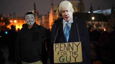 People with a Boris Johnson cardboard cut-out taking part in the Million Mask March 2021 in Parliament Square, London. Picture date: Friday November 5, 2021.